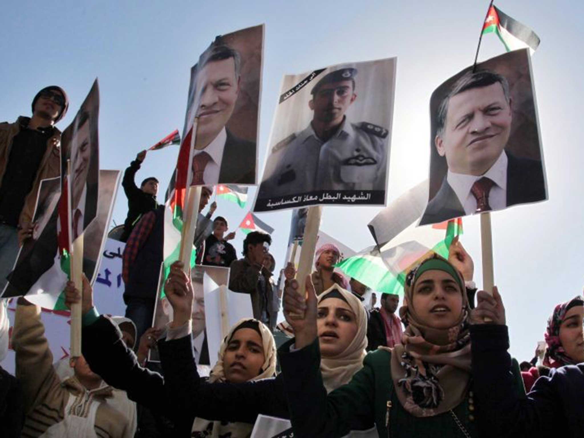 Jordanians carry pictures of him at a protest against Isis