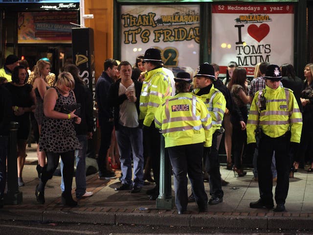 Police mingle amongst revellers as they walk and gather between the various pubs and clubs in Broad Street, the heartland of nightclubs and bars in Birmingham City centre