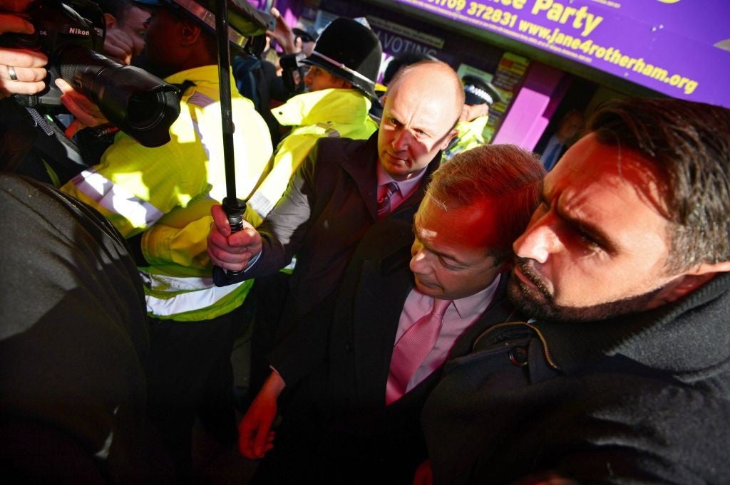 Nigel Farage is escorted out of the building in Rotherham with police help