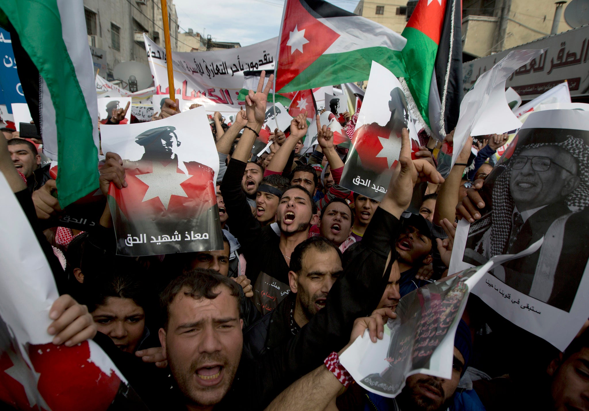 Demonstrators chant anti-Islamic State group slogans and carry posters with pictures of late King Hussein and slain Jordanian pilot, Lt. Muath al-Kaseasbeh