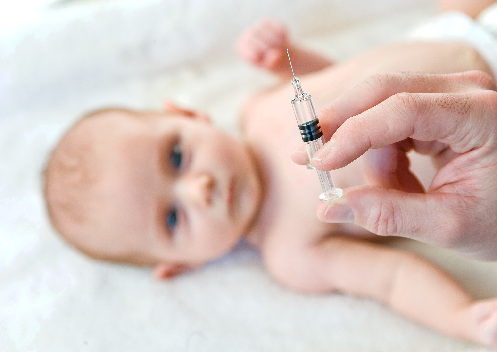 A two-month-old baby receives a vaccination