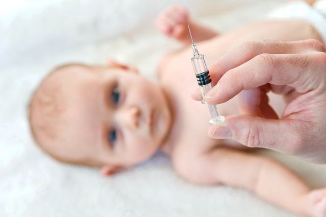 A two-month-old baby receives a vaccination