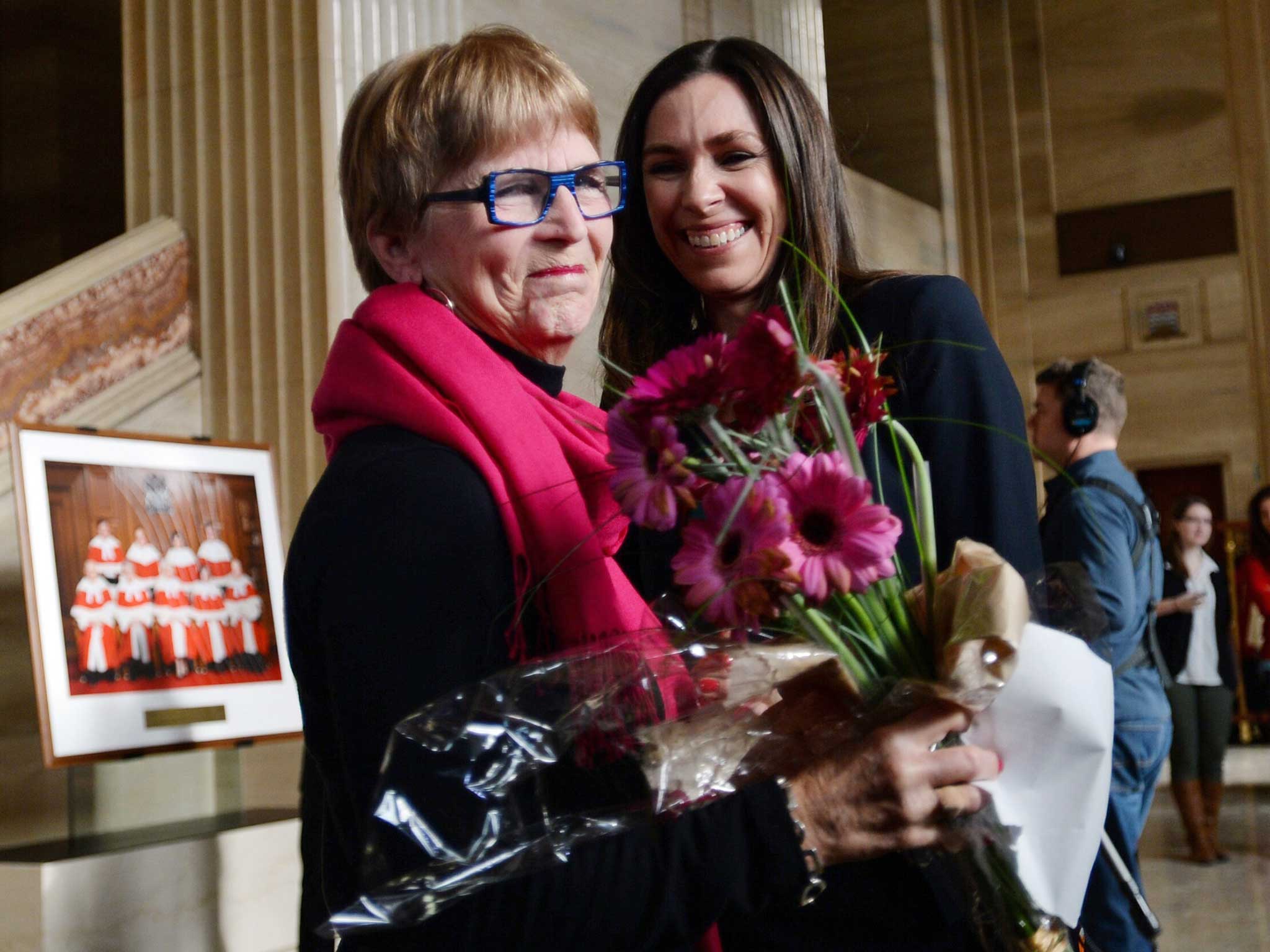 Lee Carter, left, and Grace Pastine, litigation director of the British Columbia Civil Liberties Association, celebrate their victory inside The Supreme Court of Canada