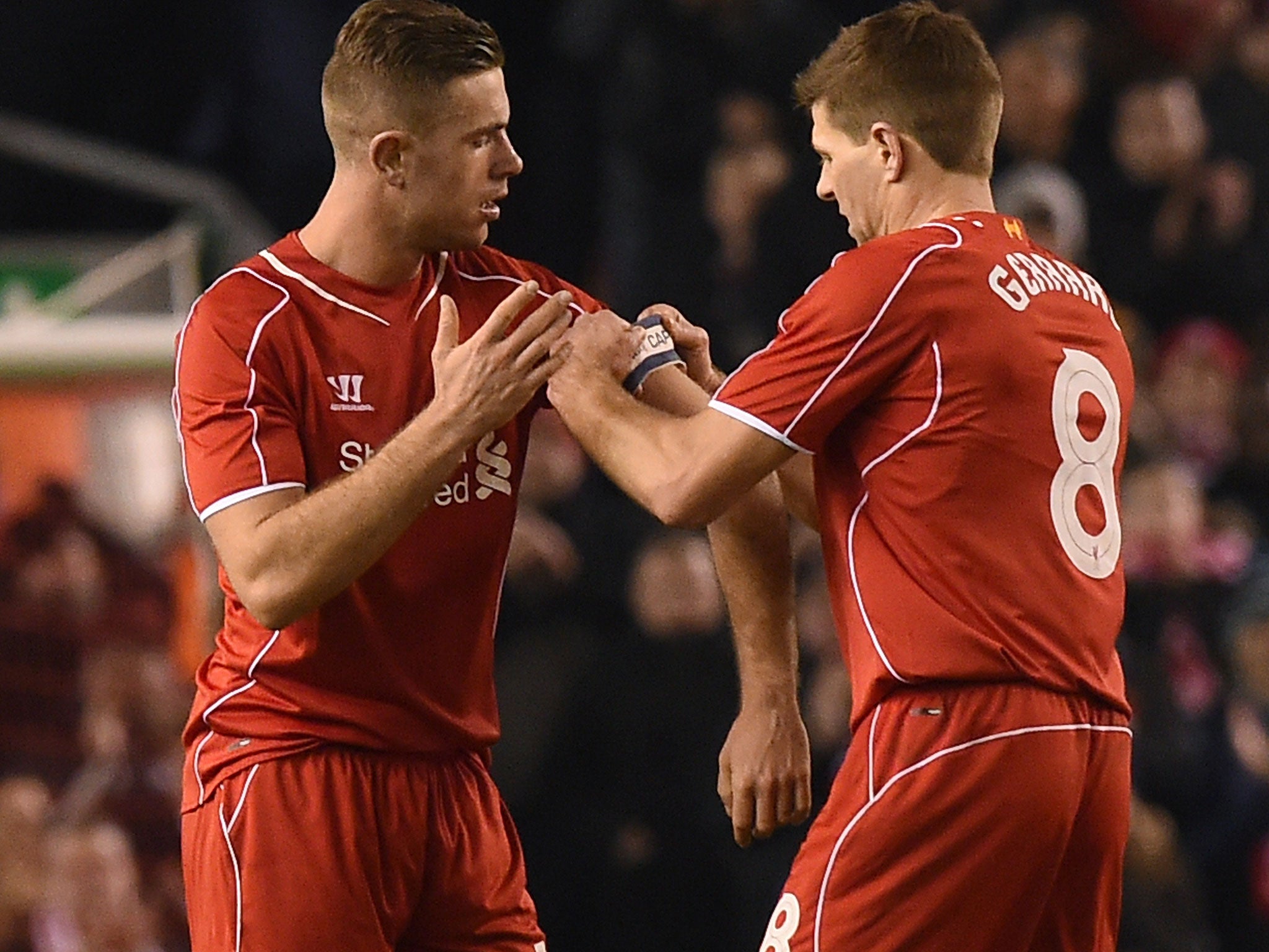 Henderson receives the captain's armband from Steven Gerrard