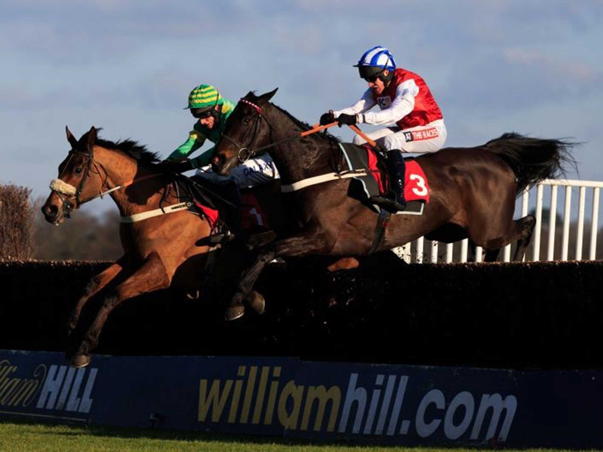 Third Intention (left), ridden by Daryl Jacob, holds the edge over the odds-on Josses Hill at the last in Kempton’s Graduation Chase yesterday