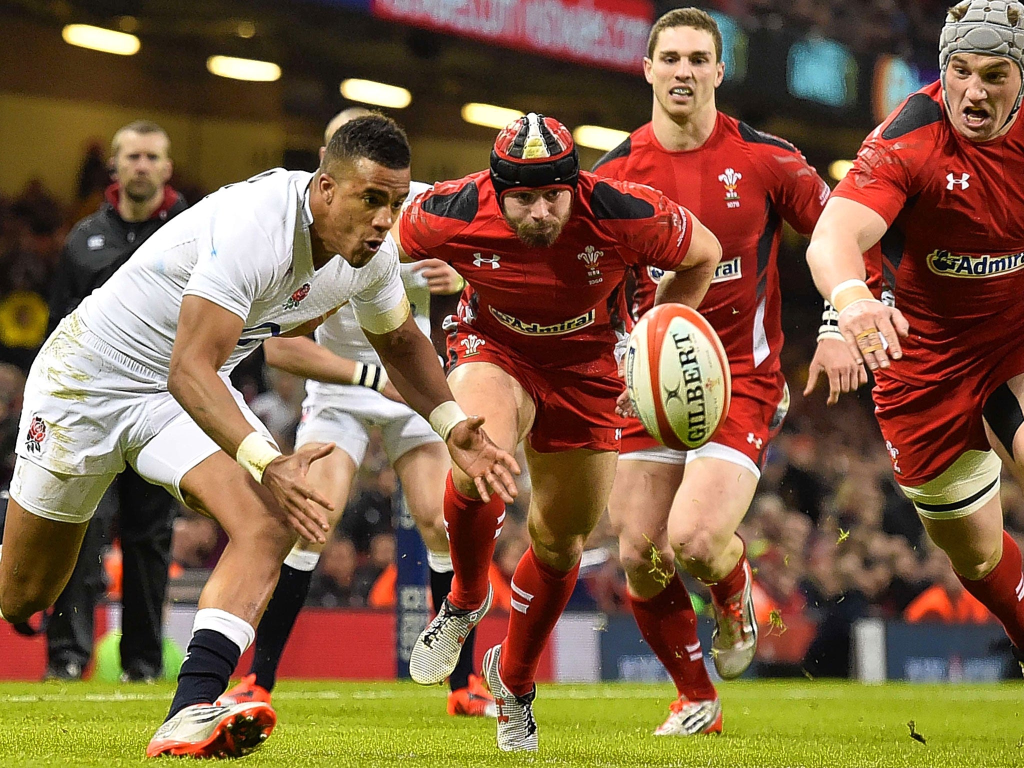 England's wing Anthony Watson (left) collects the ball to score the try