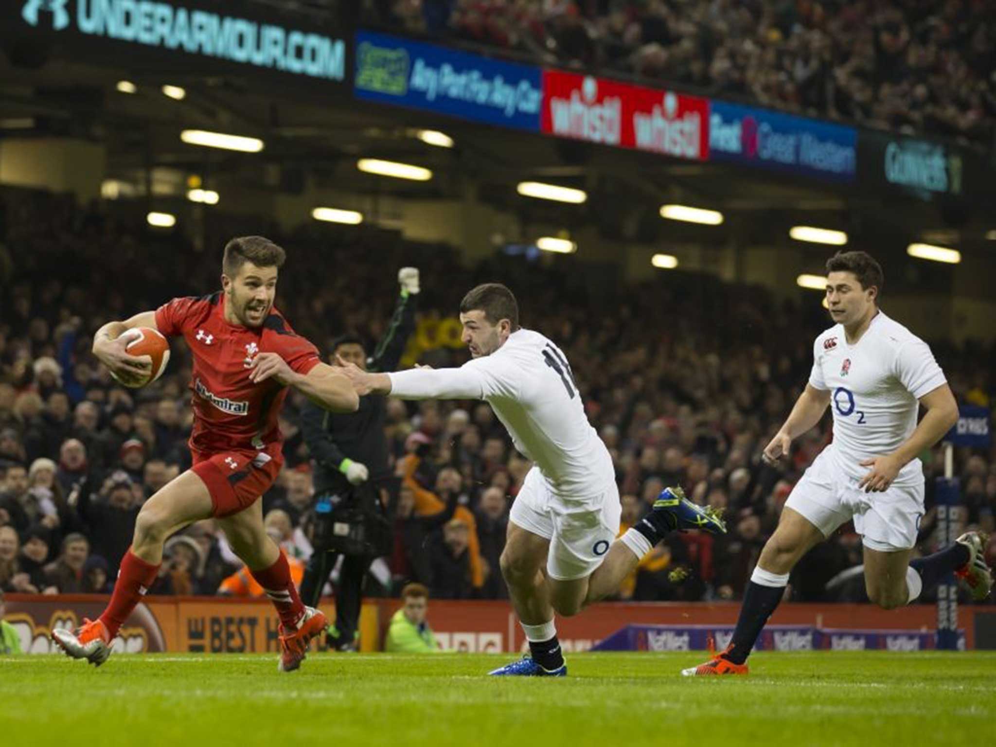 Wales’ Rhys Webb avoids an attempted tackle by England’s Jonny May as he heads over to score at the Millennium Stadium last night