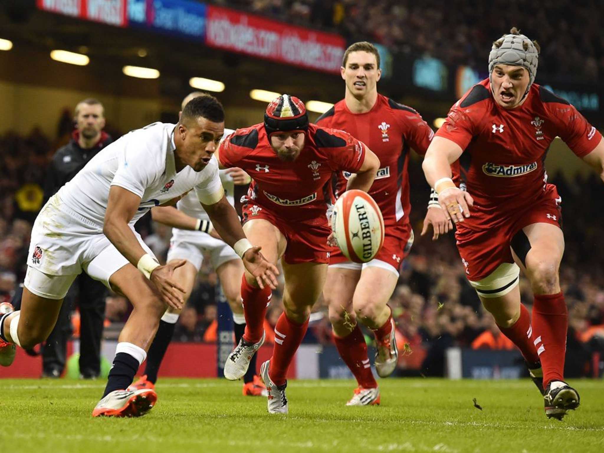 Anthony Watson (left) beats the Wales cover to score England’s first try