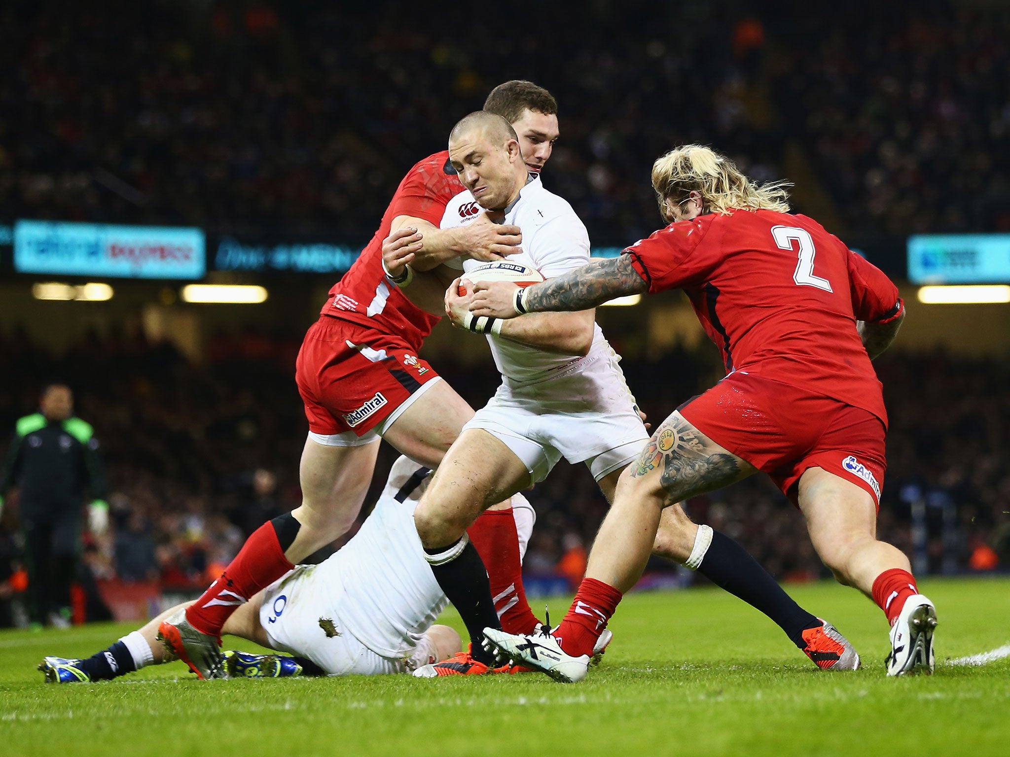 Wales wing George North and hooker Richard Hibbard tackle Mike Brown