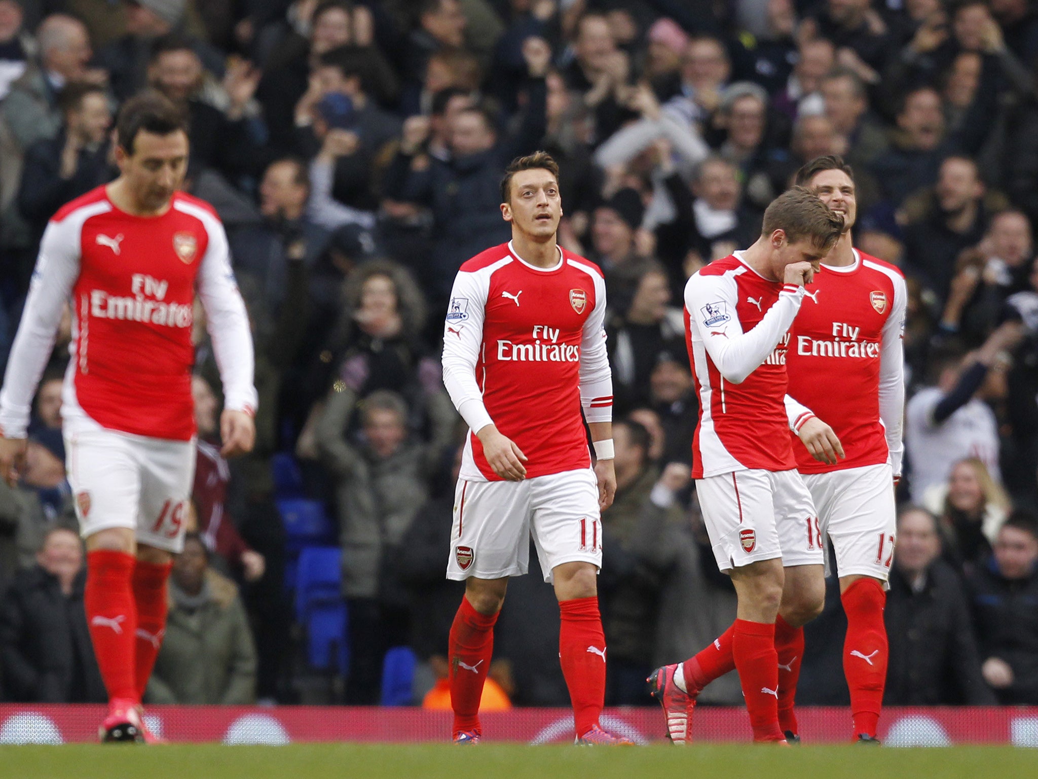 Mesut Ozil (centre) reacts to Spurs' decisive second goal