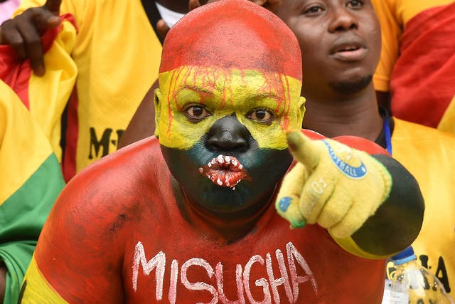 A Ghanaian fan cheers for his team 