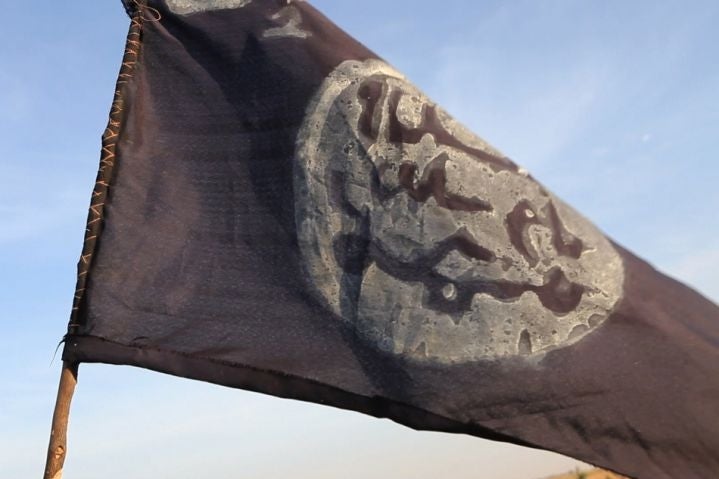 Boko Haram flag flutters from an abandoned command post in Gamboru deserted after Chadian troops chased them from the border town
