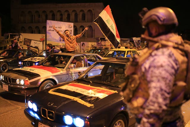 Iraqis celebrate the end of the midnight curfew in the centre of the city