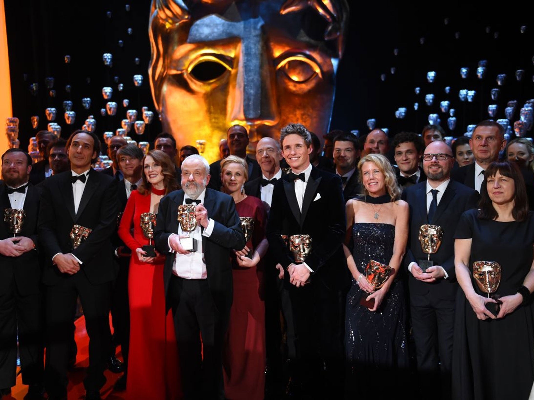 Winners pose on the stage during the Baftas