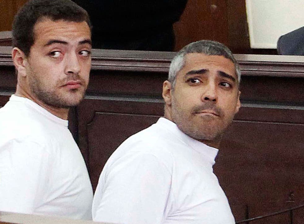 Al-Jazeera English producer Baher Mohamed, left, and  Canadian-Egyptian acting Cairo bureau chief Mohammed Fahmy, right, during their previous appearance in court 