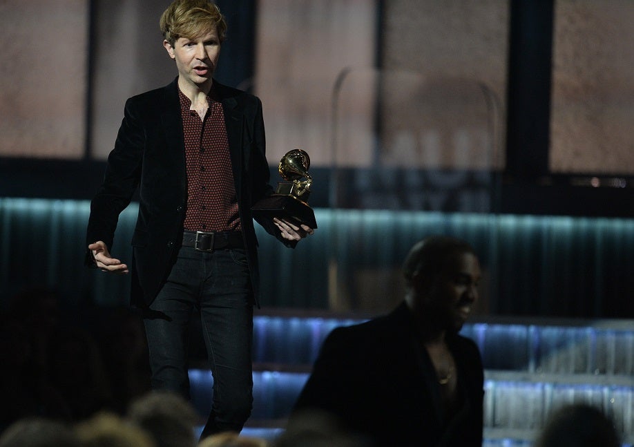 Album of the Year winner Beck jests with Kanye West after the rapper poked fun at the previous controversy over his Taylor Swift interjection by jumping up during Beck's speech