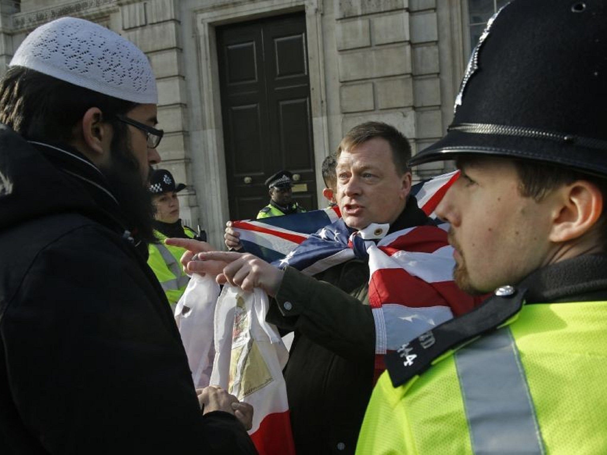 A member of Britain First talking with a Muslim protester on Whitehall