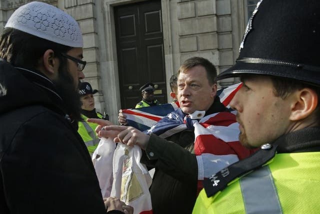 A member of Britain First talking with a Muslim protester on Whitehall