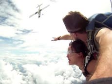 skydivers' parachute gets caught by plane's propeller