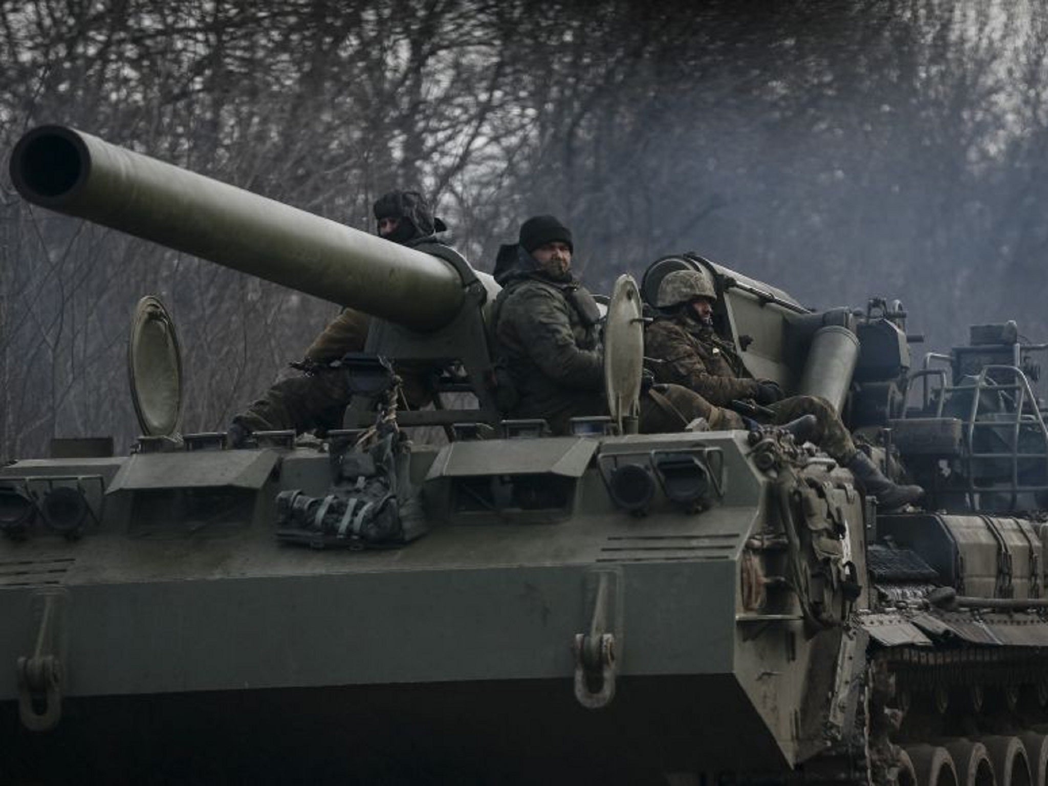 Ukrainian soldiers ride on a self-propelled howitzer near Debaltseve, eastern Ukraine