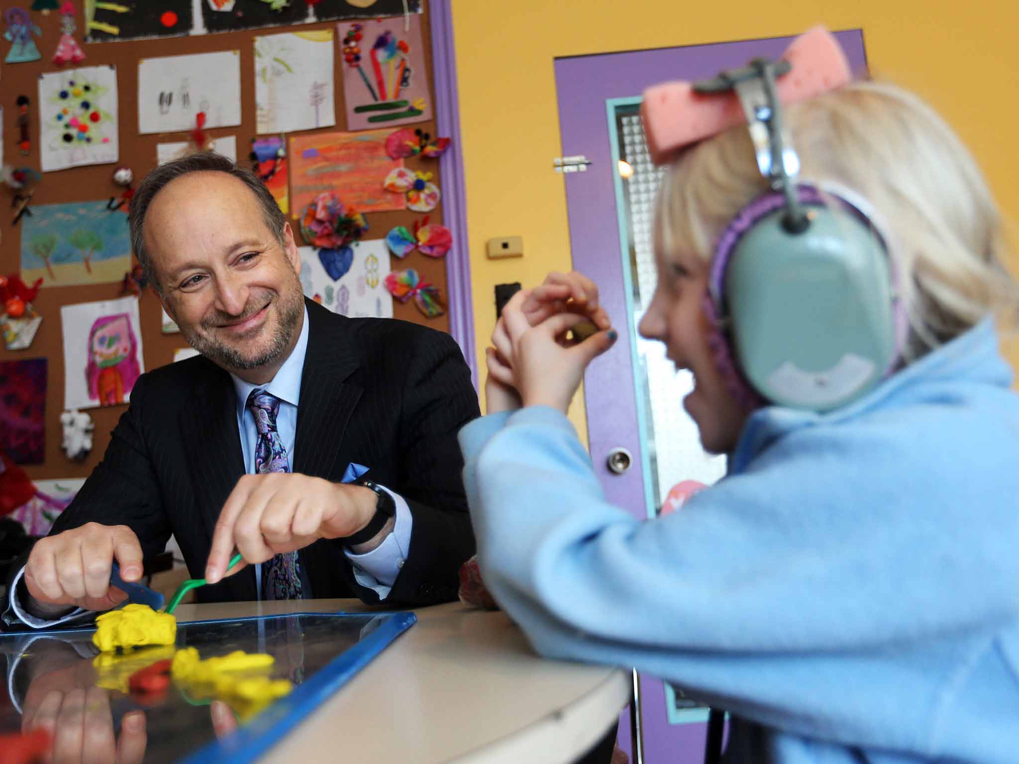Dr Norman Doidge at The Learning Centre in Toronto, where a young patient is receiving brain stimulation