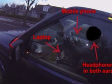 Video catches driver 'using laptop, mobile phone and headphones' while