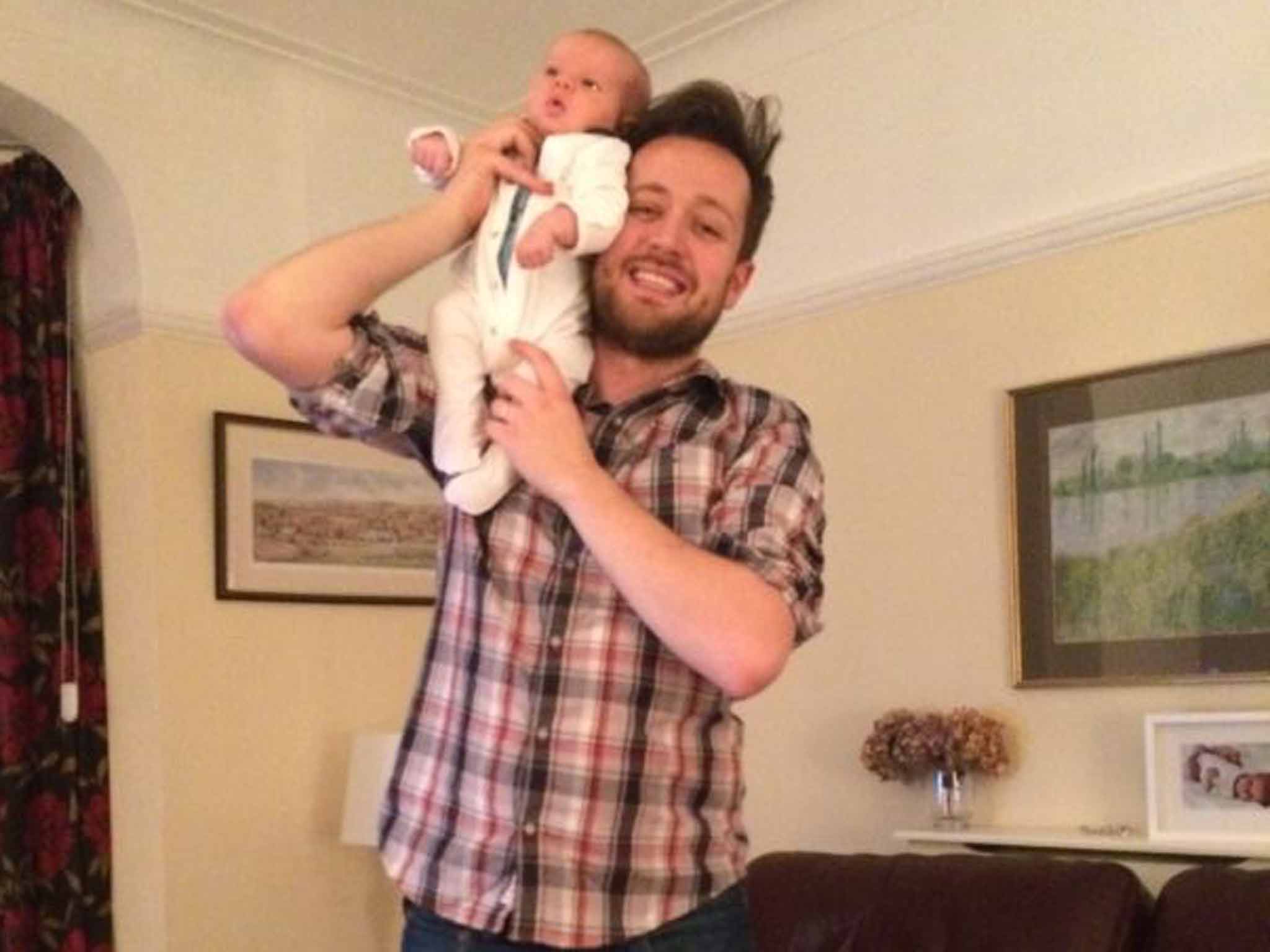 Baby bond: writer Will Dean at home with his newborn baby, Johnny