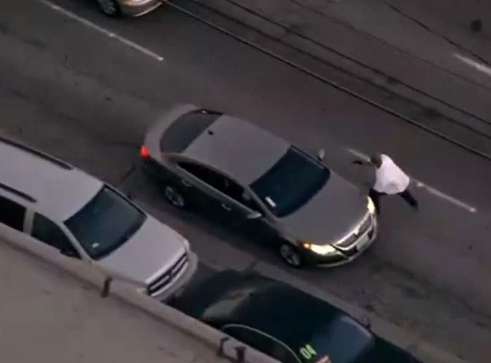 The suspect hijacking the second car used in the chase through LA