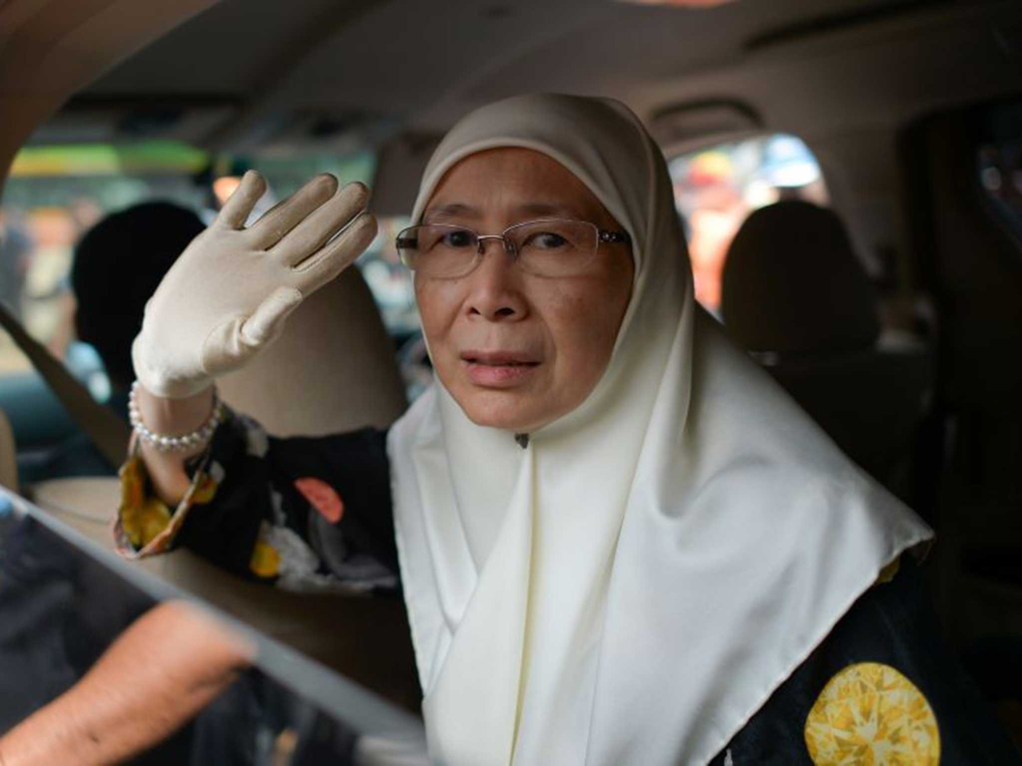 Wan Azizah, wife of Malaysian opposition leader Anwar Ibrahim, waves as she leaves the federal court