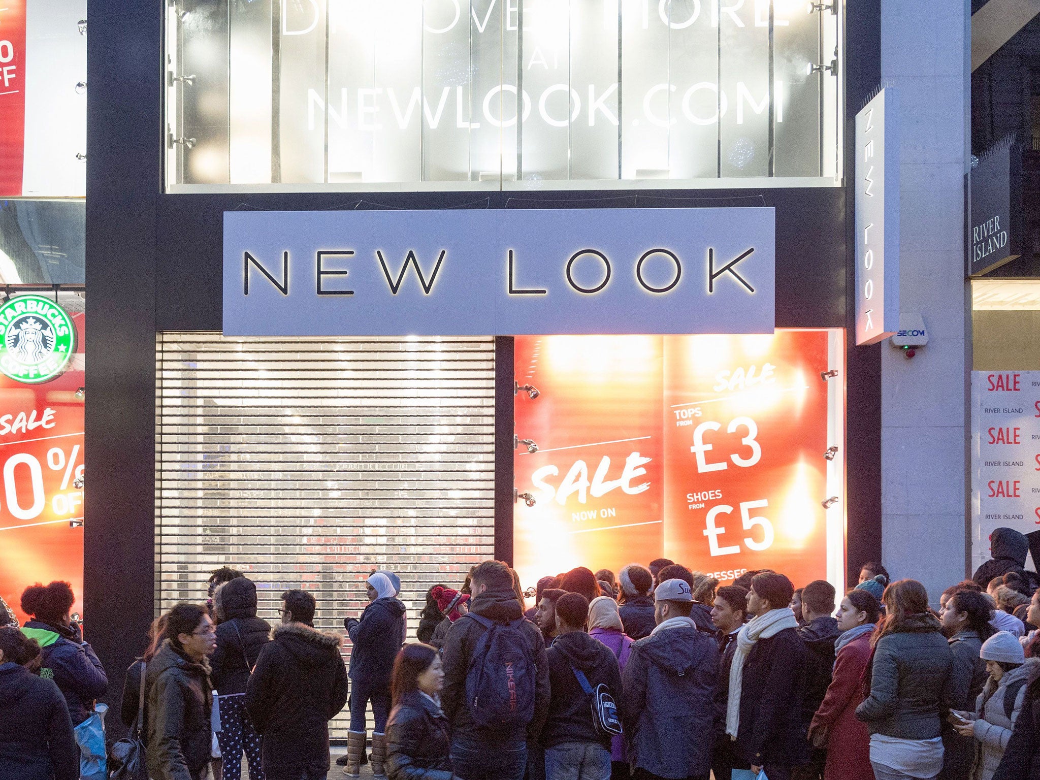 Customers queuing outside a New Look store in Oxford Street on Boxing Day, 2013