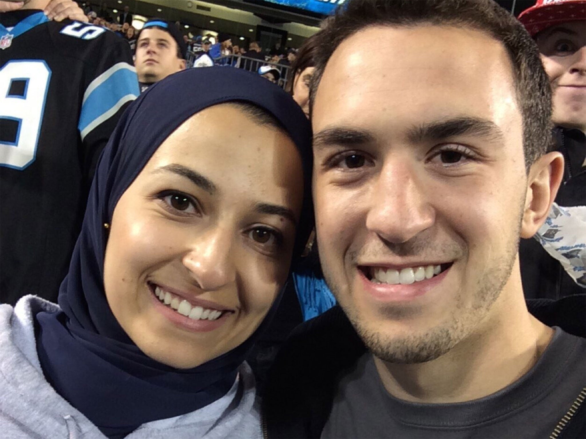 Deah Barakat and his wife Yusor at an American football match