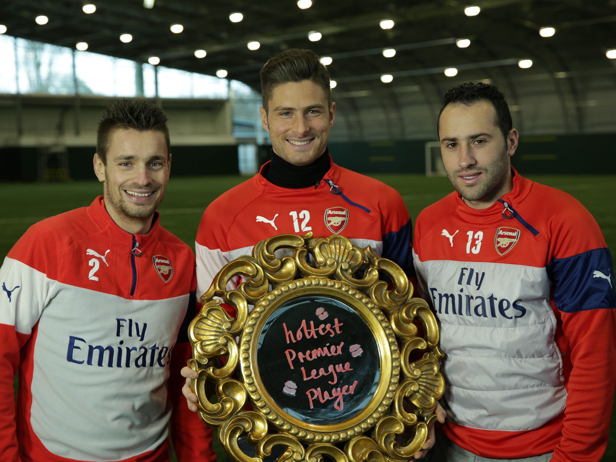 Olivier Giroud holds his trophy alongside team-mates Mathieu Debuchy (left) and David Ospina (right)
