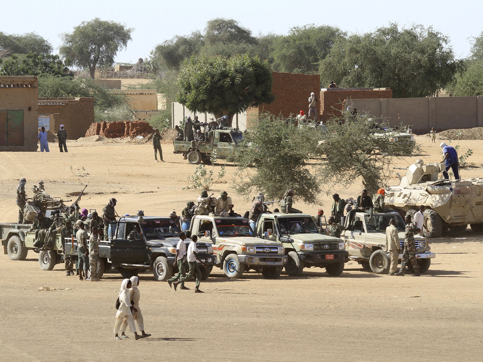 Sudanese troops standing guard in the village of Tabit, in the North Darfur, last November (Getty)