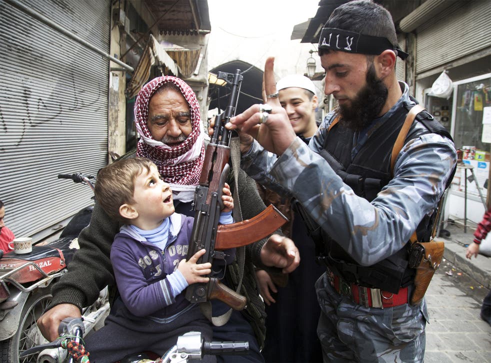 Young guns: a rebel soldier has no qualms about showing a little boy the best way to hold an AK-47 for a photo opportunity