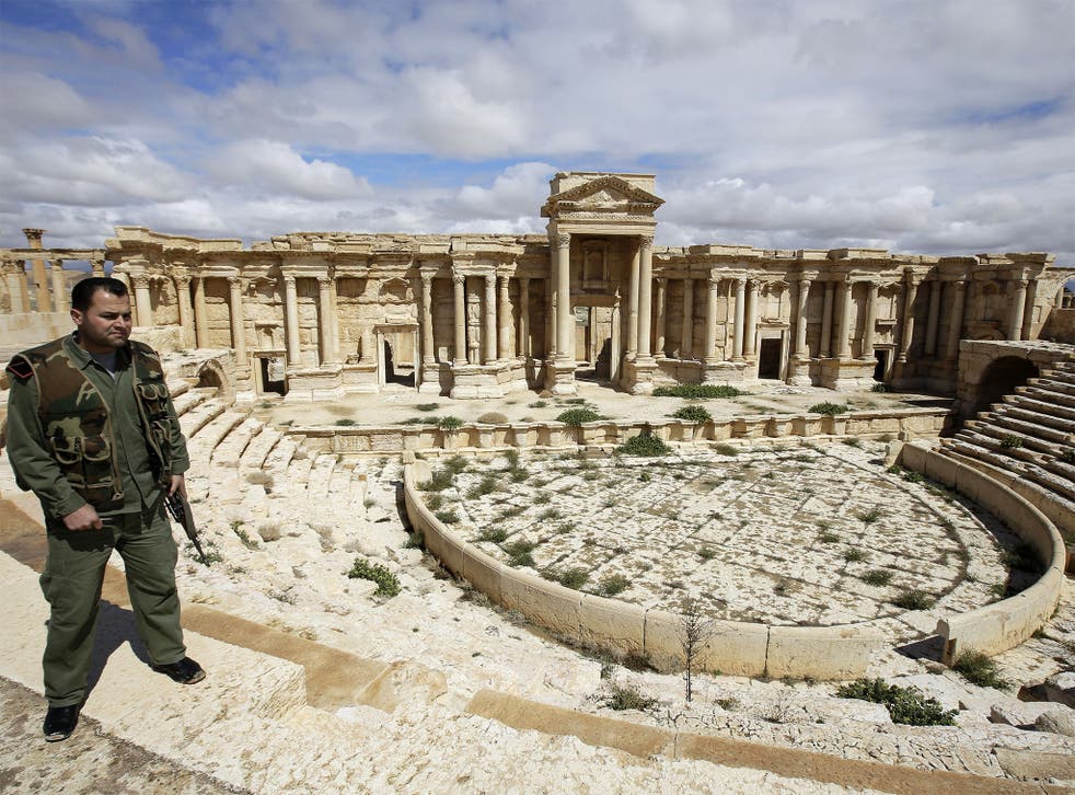 A Syrian police officer patrols the ancient city of Palmyra