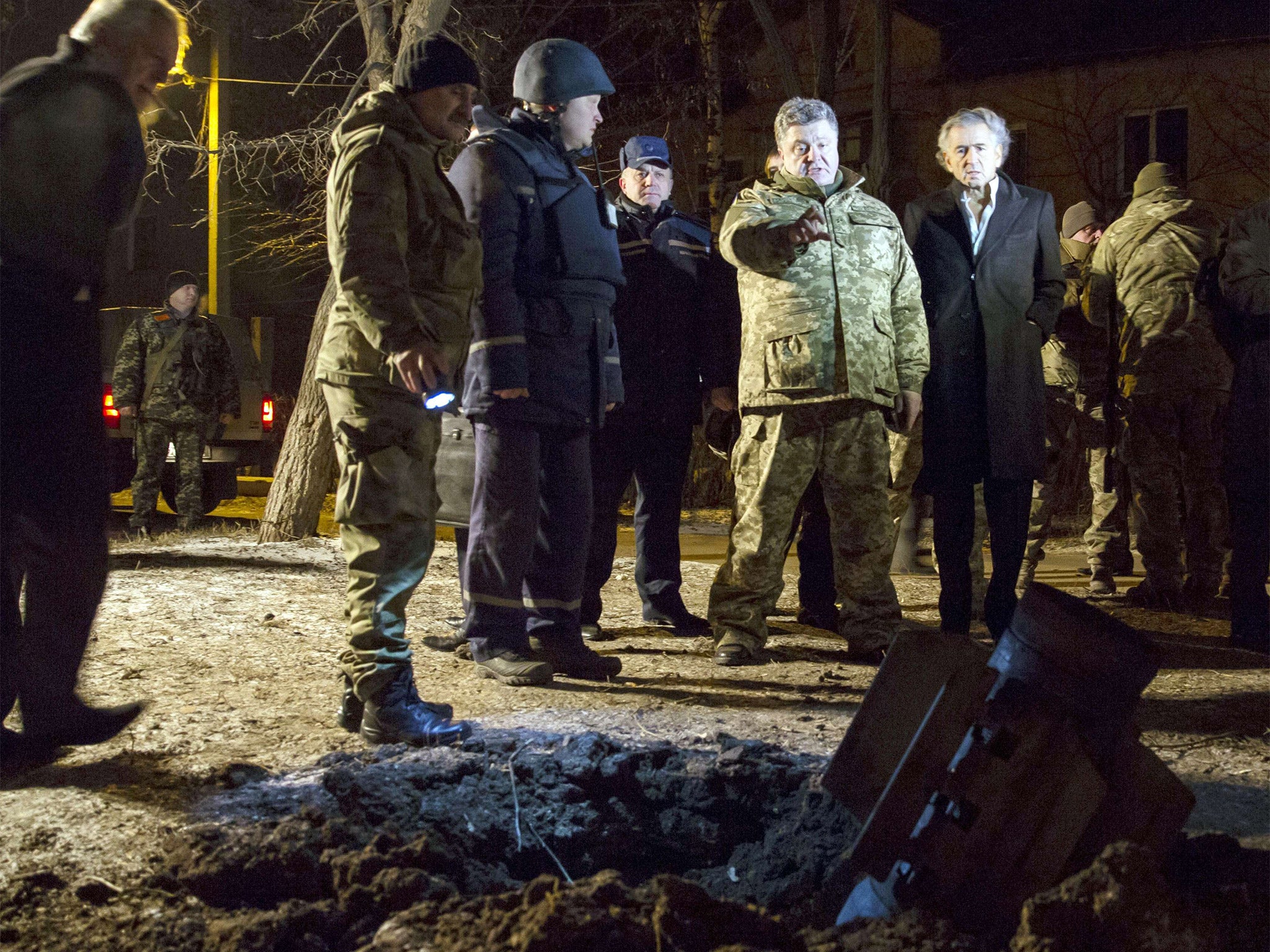 Ukrainian President Petro Poroshenko, second right, looking at an unexploded rocket in the eastern Ukrainian city of Kramatorsk (AP)