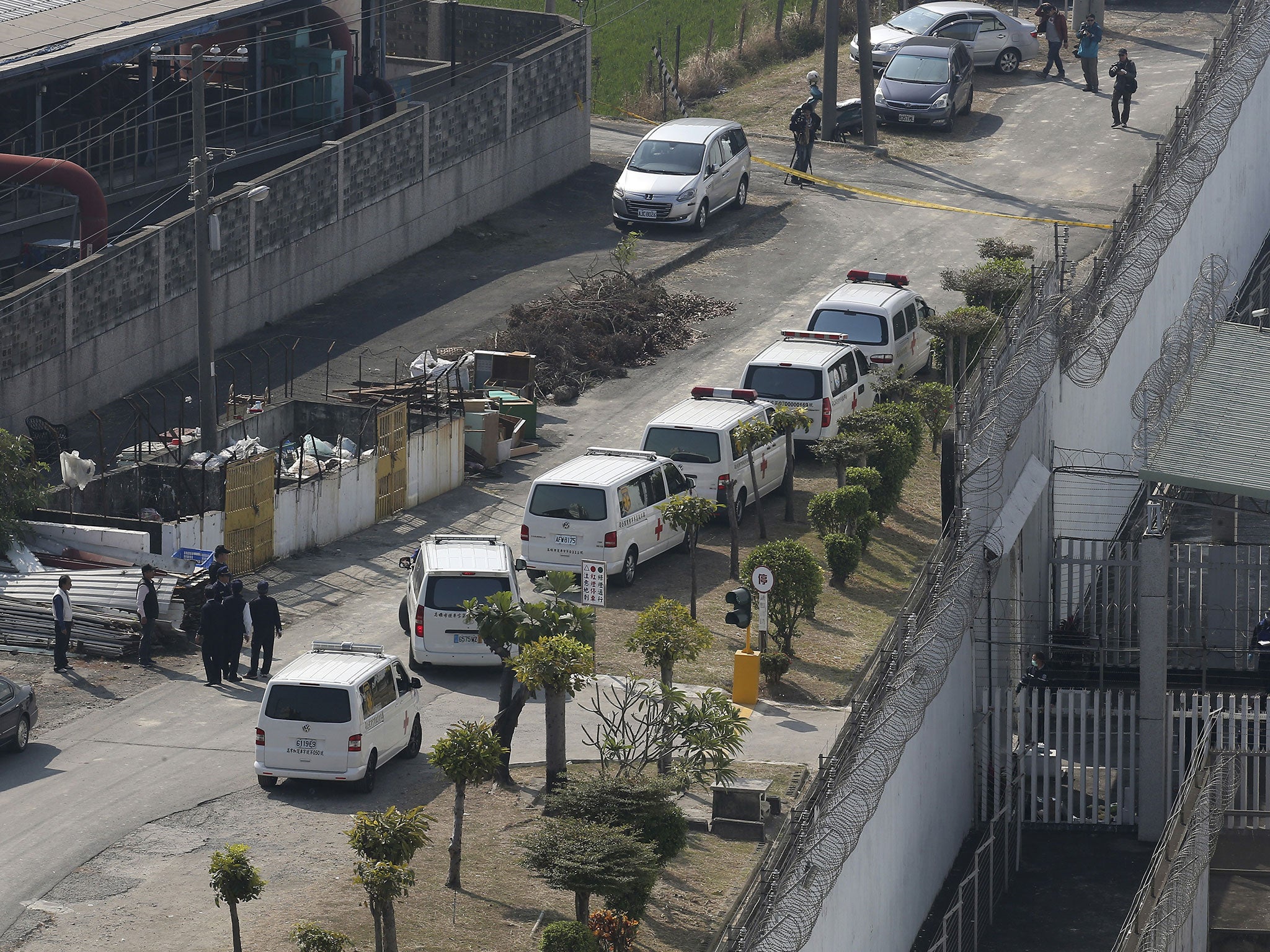 Ambulances wait outside of a prison after a standoff hostage situation in Kaohsiung