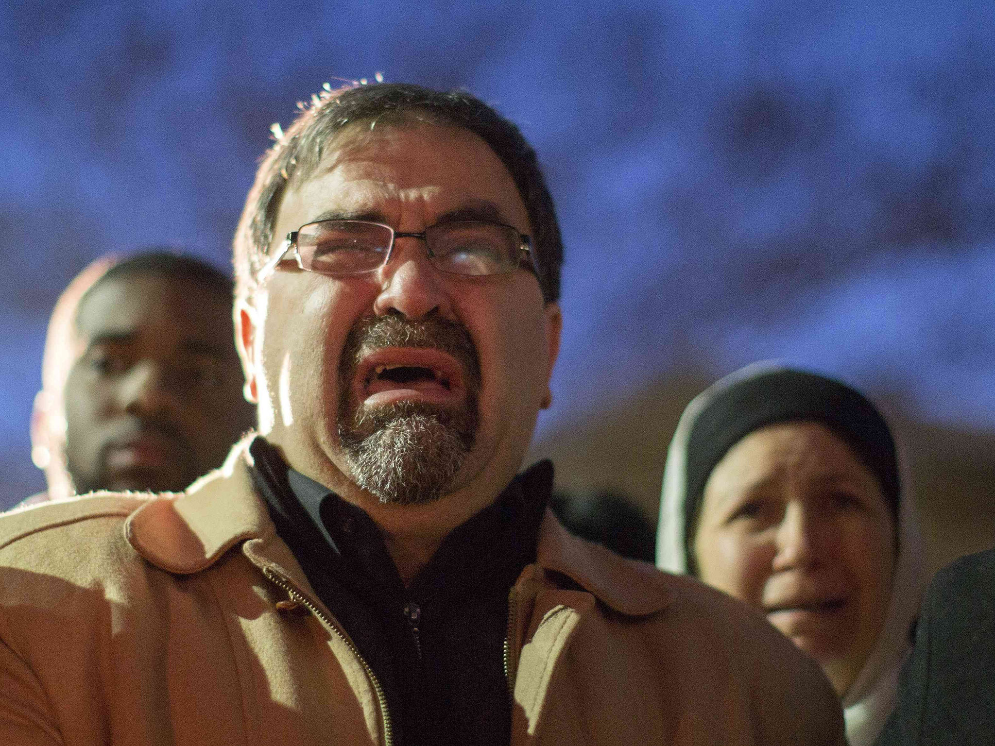 Namee Barakat, father of shooting victim Deah Shaddy Barakat, cries as a video is played during the vigil