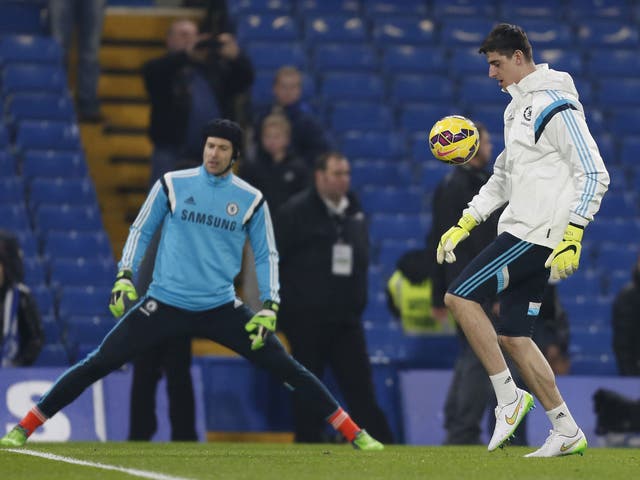 Thibaut Courtois warms up before the match with Everton with Petr Cech in the background