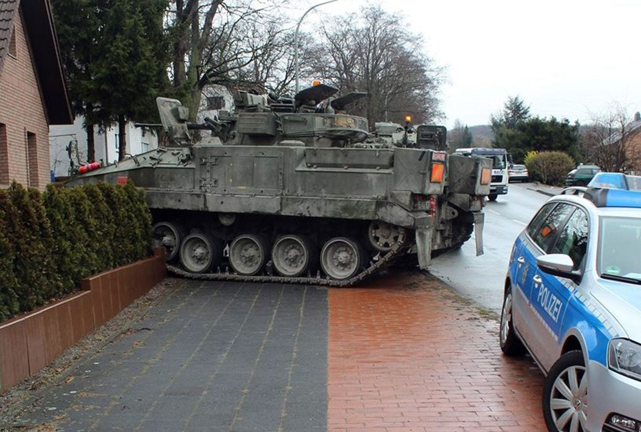 A tank rolls into a yard in Paderborn, Germany. A technical malfunction with a drive chain reportedly led the British tank to deviate from the street and into a yard