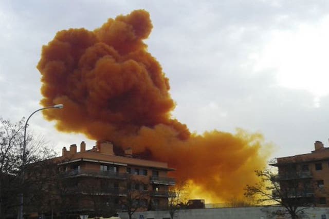 An orange toxic cloud is seen over the town of Igualada, near Barcelona