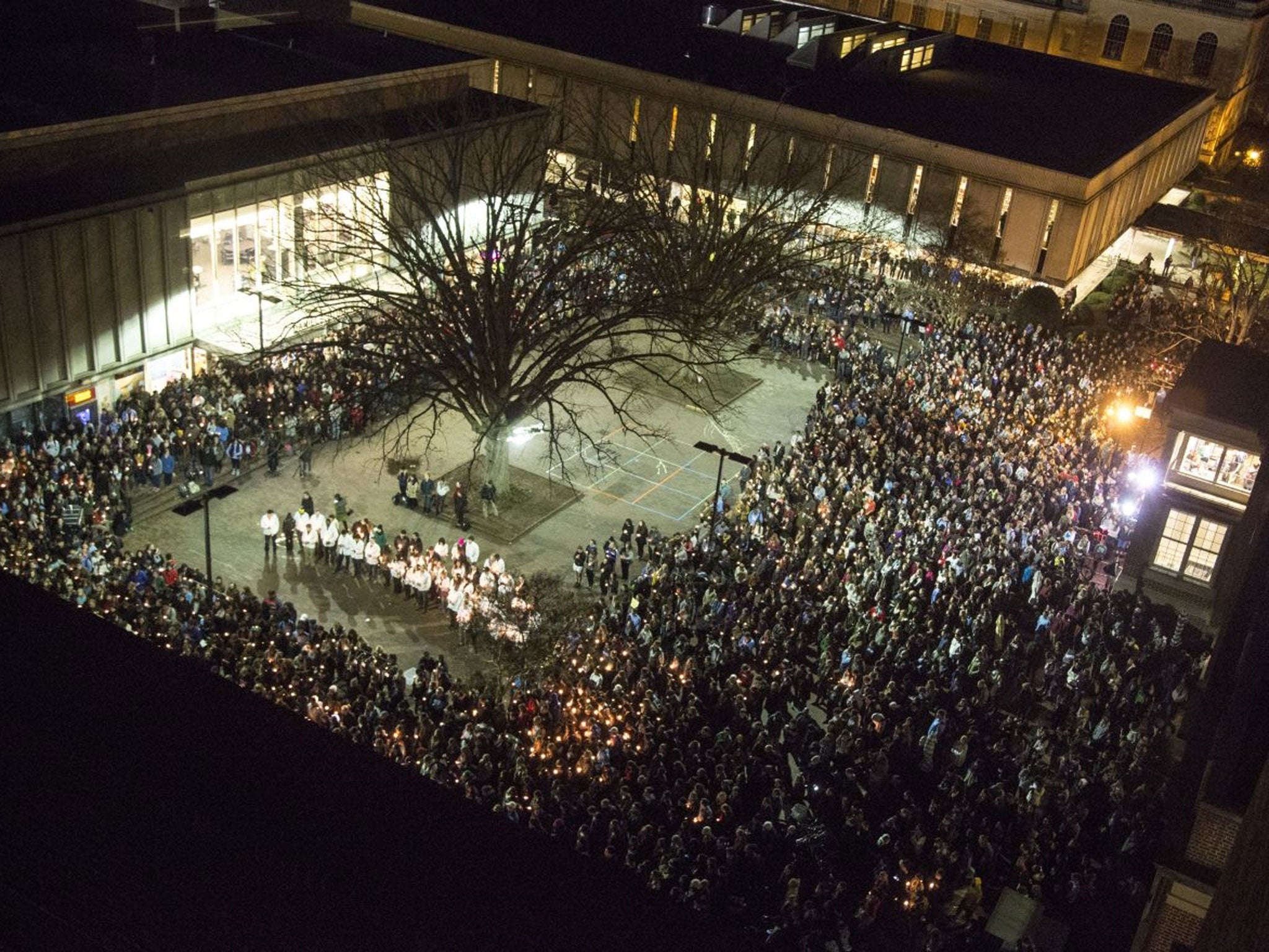 People gather at UNC-Chapel Hill's "Pit" to mourn for Deah Shaddy Barakat, his wife Yusor Mohammed and her sister Razan Mohammed Abu-Salha in Chapel Hill, N.C., Wednesday, Feb. 11, 2015.