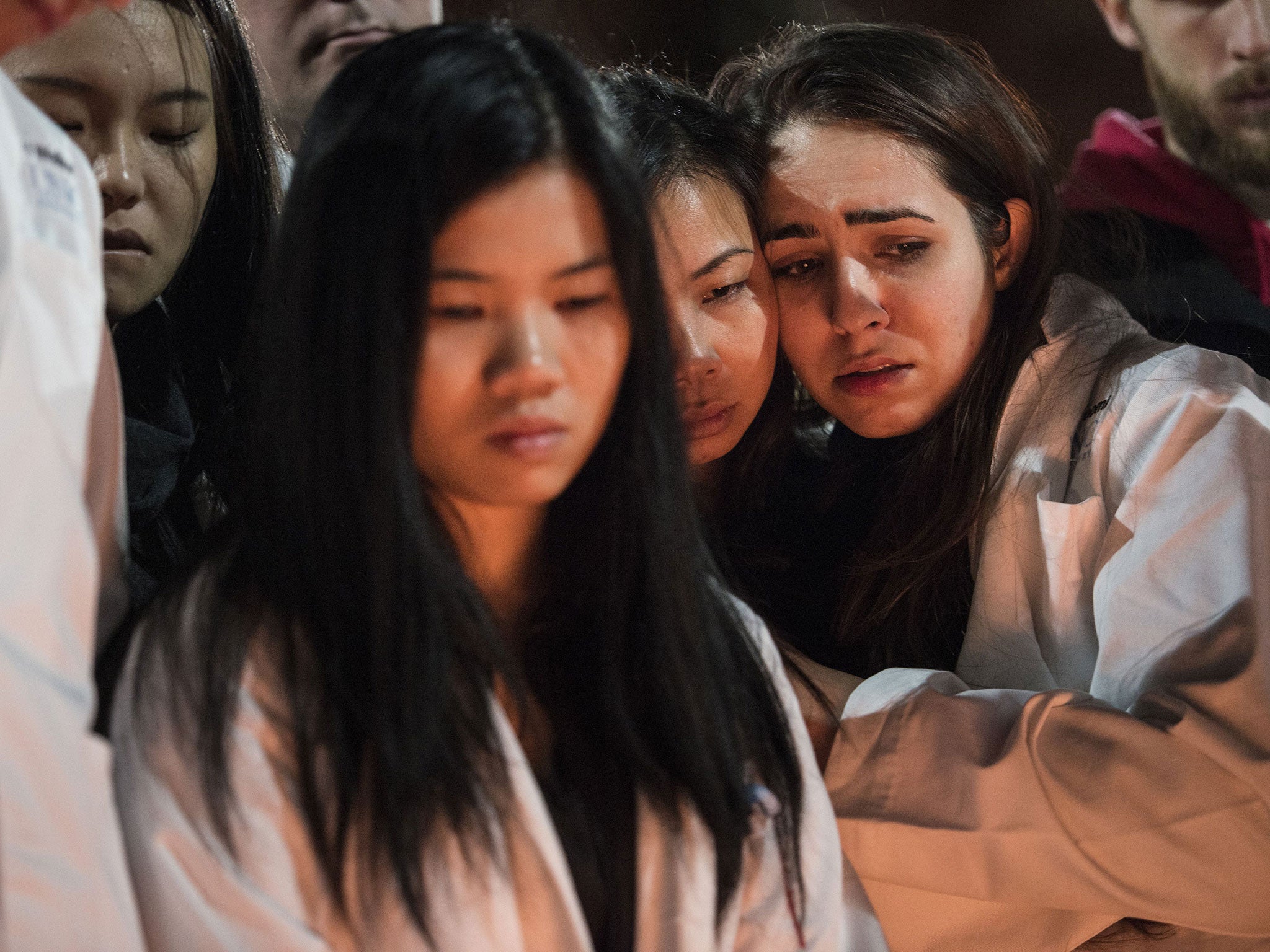 Dentistry students and others huddle together during the vigil at the University of North Carolina (Getty Images)