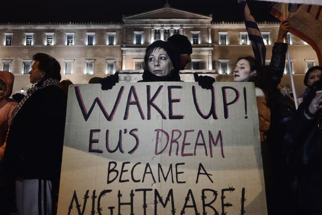 Anti-austerity protesters march outside the Greek parliament in Athens