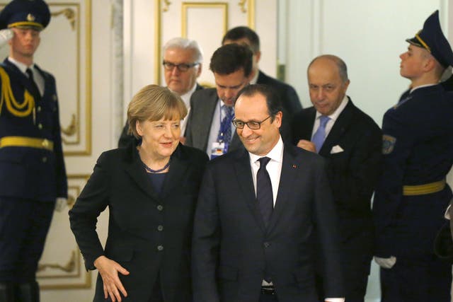 Angela Merkel and François Hollande emerge from their marathon talks in Minsk yesterday 
