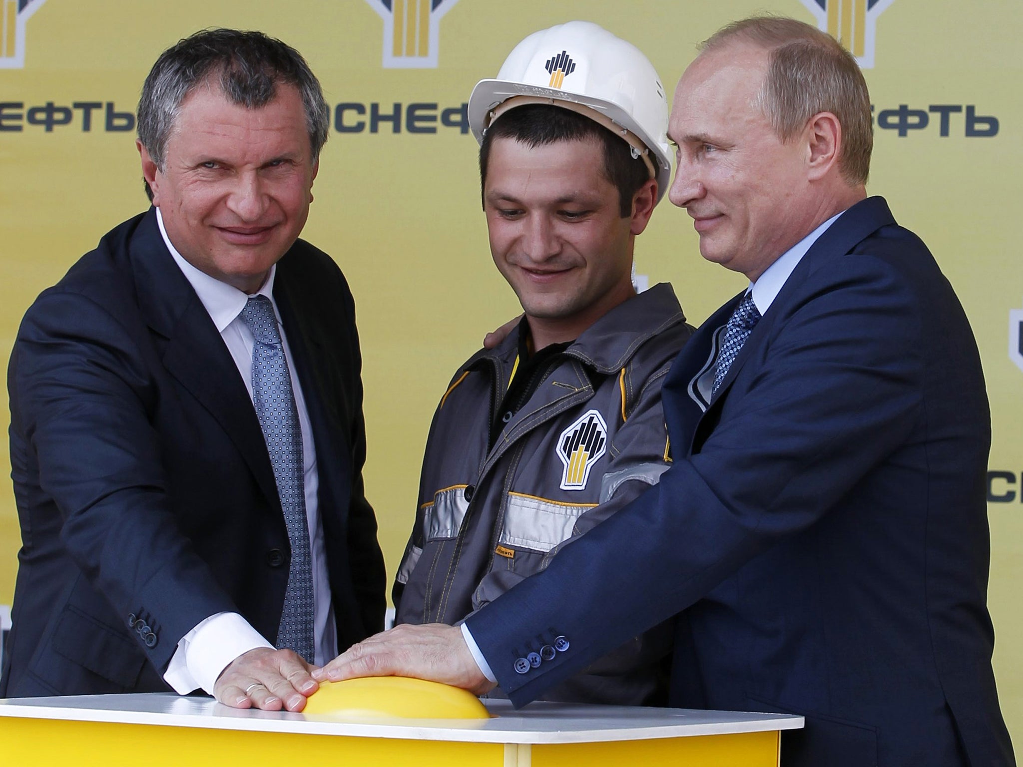 President Putin and Igor Sechin (left) push the button launching a new oil terminal in 2012 (Getty)