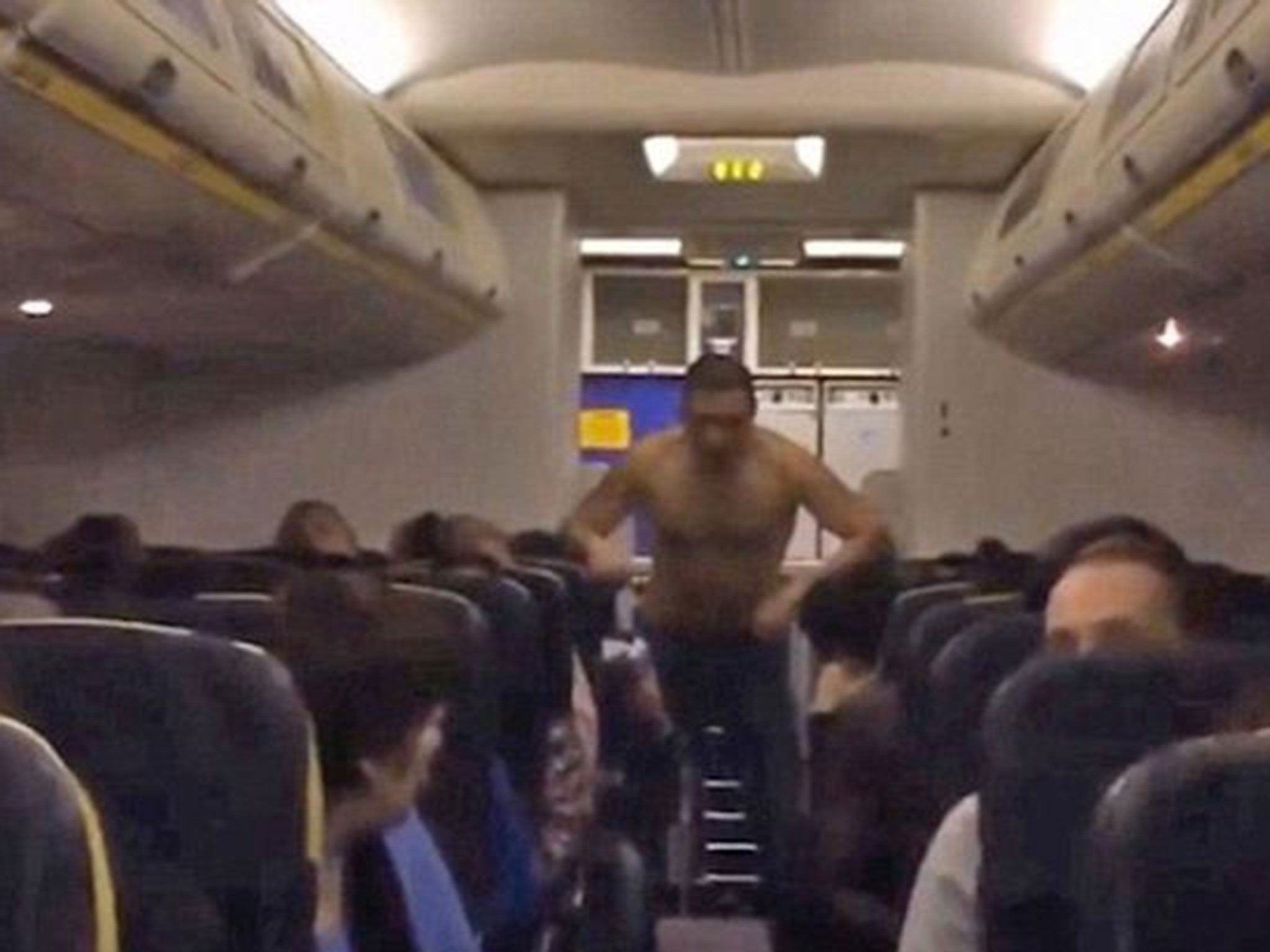 A group of passengers helped to restrain the man after he began leaning on the seats of passengers