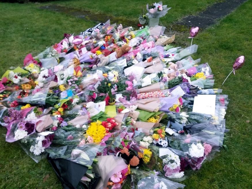 Floral tributes left at Weston Free Church for the four victims of the incident (PA)