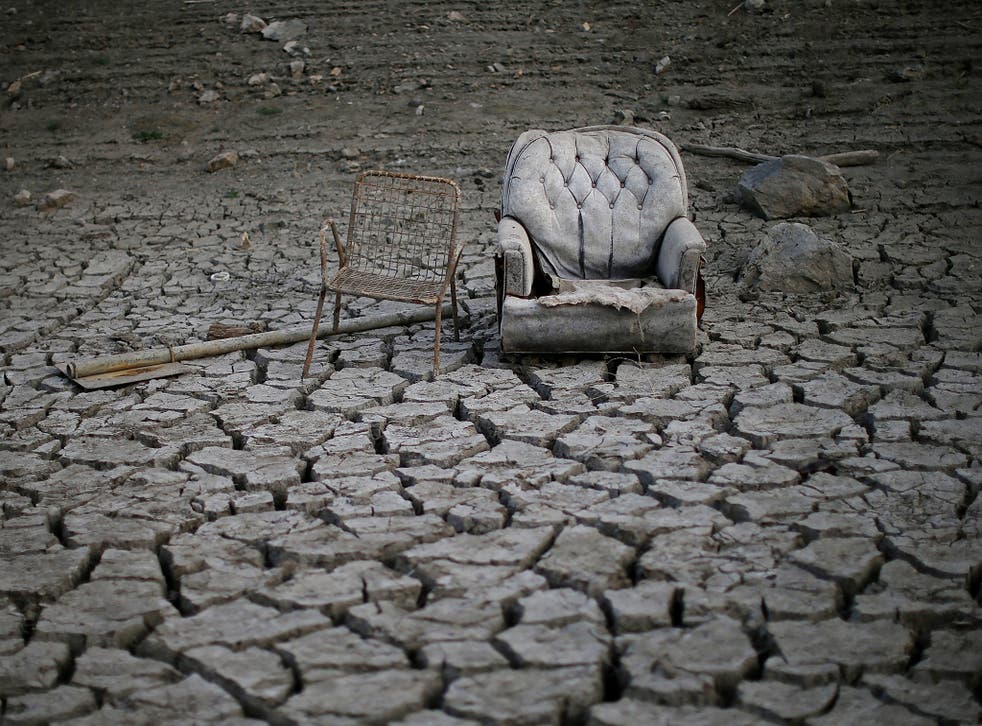 Chairs sit in dried and cracked earth that used to be the bottom of the Almaden Reservoir in San Jose, California. The state is experiencing its driest year on records that date back 119 years