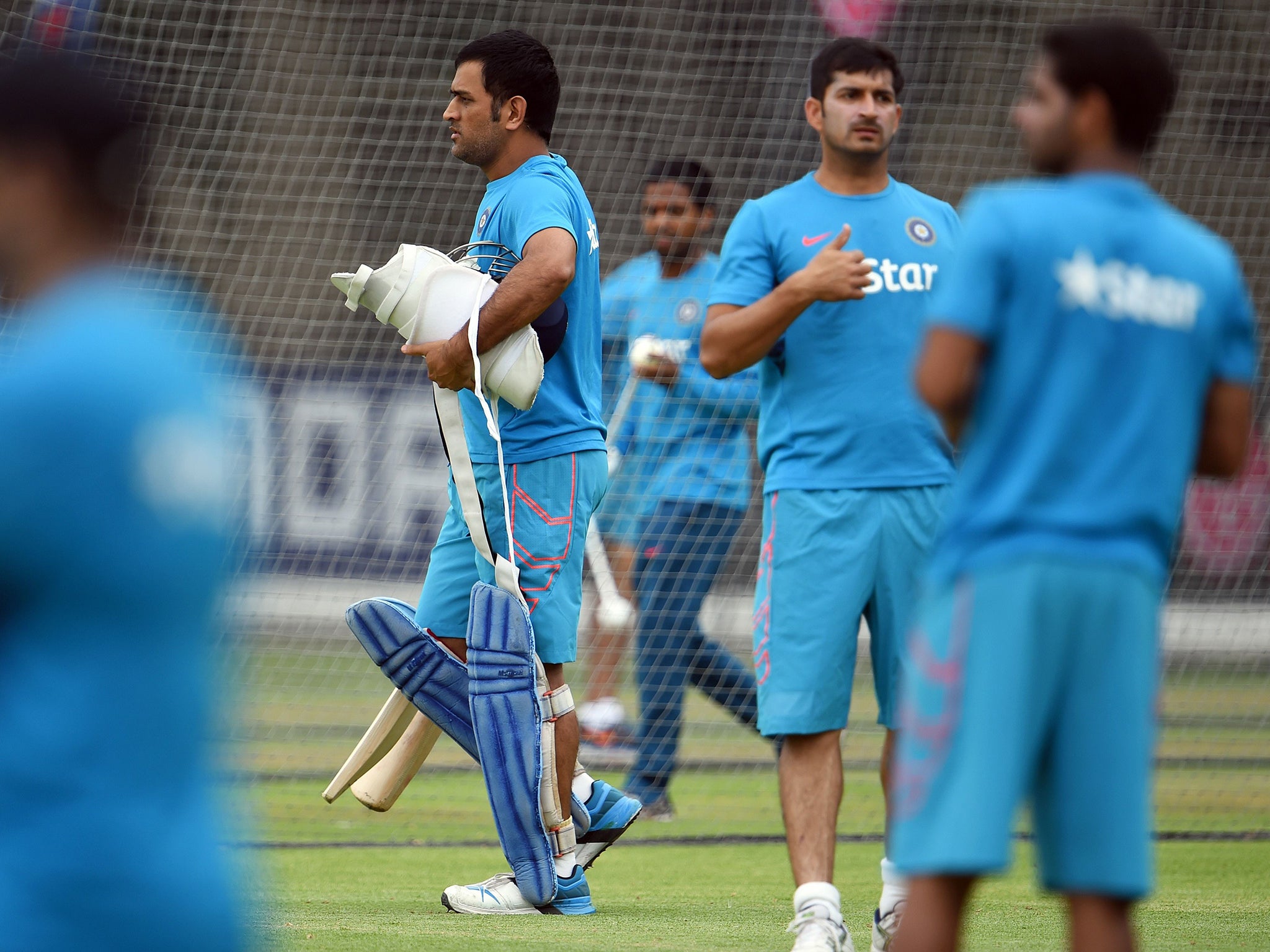 MS Dhoni, who will lead India against Pakistan tomorrow, walks out to bat during
a training session in Adelaide yesterday